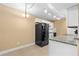 Kitchen featuring white cabinets, granite countertops, and modern black appliances at 1600 Big Tree Rd # G3, South Daytona, FL 32119
