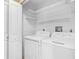 Laundry room with newer, white washer and dryer and built in shelves at 1600 Big Tree Rd # G3, South Daytona, FL 32119