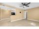 Open living room with tiled floors, ceiling fan, and easy flow into the kitchen area at 1600 Big Tree Rd # G3, South Daytona, FL 32119