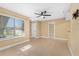 Spacious living room with tile flooring, ceiling fan, and natural light from a large window at 1600 Big Tree Rd # G3, South Daytona, FL 32119