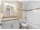 This bathroom features a white vanity, a tub with tile surround and decorative accent tile at 1600 Big Tree Rd # I2, South Daytona, FL 32119