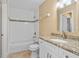 Bathroom features a granite countertop, white cabinetry, and tiled shower over tub at 1600 Big Tree Rd # I2, South Daytona, FL 32119