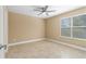 A bedroom with neutral walls, tile flooring and a large window for natural light at 1600 Big Tree Rd # I2, South Daytona, FL 32119