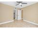 This bedroom features neutral walls, tile flooring, ceiling fan, and a closet at 1600 Big Tree Rd # I2, South Daytona, FL 32119