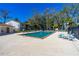 Community pool featuring lounge seating and shade trees on a sunny day at 1600 Big Tree Rd # I2, South Daytona, FL 32119