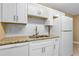 This kitchen features granite countertops, white cabinets and stainless steel appliances at 1600 Big Tree Rd # I2, South Daytona, FL 32119