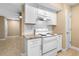 The kitchen features granite countertops, white cabinets and stainless steel appliances at 1600 Big Tree Rd # I2, South Daytona, FL 32119