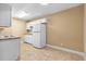 This kitchen features tile flooring, ample cabinet storage and a white refrigerator at 1600 Big Tree Rd # I2, South Daytona, FL 32119