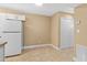 Bright room with neutral walls, tile flooring, a white refrigerator, and closet space at 1600 Big Tree Rd # I2, South Daytona, FL 32119