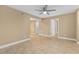 Bright living room with neutral walls, tile flooring, ceiling fan, and multiple entryways at 1600 Big Tree Rd # I2, South Daytona, FL 32119