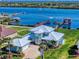 Stunning waterfront home featuring manicured lawn, expansive driveway, and private dock access at 2019 S Riverside, Edgewater, FL 32141