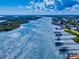A high-angle aerial view of a waterfront community and river with docks and boatlifts at 2019 S Riverside, Edgewater, FL 32141