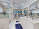 Elegant bathroom with a glass enclosed shower, double sinks with white cabinets, and modern fixtures at 2019 S Riverside, Edgewater, FL 32141