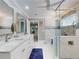 Modern bathroom with double sinks, white cabinets, a glass enclosed shower, and bathtub at 2019 S Riverside, Edgewater, FL 32141
