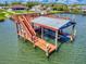 A well-maintained boat dock featuring stairs, boat house and slips against the water at 2019 S Riverside, Edgewater, FL 32141