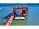 Waterfront dock showcasing a boat lift and an observation deck, providing panoramic views of the water at 2019 S Riverside, Edgewater, FL 32141