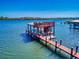 Scenic waterfront view highlighting the dock with an upper deck, perfect for boating and enjoying waterfront living at 2019 S Riverside, Edgewater, FL 32141