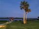 Waterfront property featuring a private dock, boatlift, and tropical landscaping at 2019 S Riverside, Edgewater, FL 32141