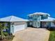 Beautiful two story home with a blue whale on its face, light landscaping, and a three car garage at 2019 S Riverside, Edgewater, FL 32141