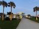 Stunning home with a long drive, lush lawn, tropical trees, and appealing exterior lighting at 2019 S Riverside, Edgewater, FL 32141