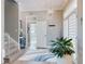 Inviting foyer with a staircase, elegant lighting, and a view into the adjacent bathroom at 2019 S Riverside, Edgewater, FL 32141