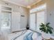 Sunlit foyer featuring a decorative rug, chandelier, and a view into an adjacent bathroom at 2019 S Riverside, Edgewater, FL 32141