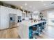 Bright kitchen with stainless steel appliances, island with bar stools, and marble countertops at 2019 S Riverside, Edgewater, FL 32141