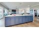 Spacious kitchen featuring marble island, open floorplan, and views into the Gathering room with fireplace at 2019 S Riverside, Edgewater, FL 32141