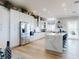 Bright, open kitchen featuring stainless steel appliances, white cabinetry, and a marble waterfall island at 2019 S Riverside, Edgewater, FL 32141