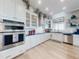 Modern kitchen boasts stainless steel appliances, white cabinets and marble countertops with a sink and dishwasher at 2019 S Riverside, Edgewater, FL 32141