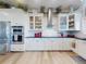 Modern kitchen features stainless steel appliances, white cabinets, and a stainless steel range hood at 2019 S Riverside, Edgewater, FL 32141