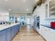 Open concept kitchen with stainless appliances, marble countertops, blue cabinets, and an island counter at 2019 S Riverside, Edgewater, FL 32141