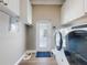 Bright laundry room with modern appliances and door leading outside at 2019 S Riverside, Edgewater, FL 32141