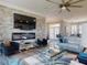 Beautiful living room with a stone accent wall, fireplace, and a large television with blue accents at 2019 S Riverside, Edgewater, FL 32141