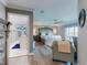 Bright main bedroom featuring wood floors, a ceiling fan, and an attached bathroom with a glass enclosed shower at 2019 S Riverside, Edgewater, FL 32141