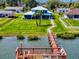 Beautiful waterfront property with a long dock leading to a boat house and upper deck, ideal for outdoor living at 2019 S Riverside, Edgewater, FL 32141