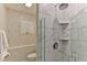 The flamingo-themed bathroom features a tiled shower with a shower head and built-in shelves at 216 Kirkland Dr, New Smyrna Beach, FL 32169