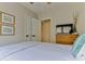 Serene bedroom featuring calming decor, neutral walls, a dresser with a TV, and coastal-themed wall art at 216 Kirkland Dr, New Smyrna Beach, FL 32169