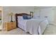 Cozy bedroom featuring a woven headboard, white linens, and beach-themed decor at 216 Kirkland Dr, New Smyrna Beach, FL 32169