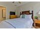 Relaxing bedroom featuring a queen bed, wicker furniture, ceiling fan, and access to an ensuite bathroom at 216 Kirkland Dr, New Smyrna Beach, FL 32169