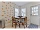Inviting breakfast nook with an exterior door, ample light, seating, and citrus-themed wallpaper at 216 Kirkland Dr, New Smyrna Beach, FL 32169