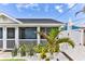 Exterior of home featuring a welcoming front porch and well-maintained landscaping at 216 Kirkland Dr, New Smyrna Beach, FL 32169