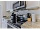 Efficient kitchen featuring stainless steel appliances, granite countertops, and sleek cabinetry at 216 Kirkland Dr, New Smyrna Beach, FL 32169