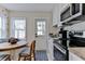 Bright eat-in kitchen features modern appliances, tiled floors, and access to outdoor space at 216 Kirkland Dr, New Smyrna Beach, FL 32169