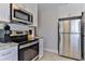 This efficient kitchen features stainless steel appliances, and white cabinetry at 216 Kirkland Dr, New Smyrna Beach, FL 32169