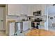 Bright kitchen with stainless steel appliances, white cabinets, and a dining table at 216 Kirkland Dr, New Smyrna Beach, FL 32169