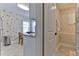Charming breakfast nook with a view into the flamingo-themed bathroom with a tiled shower at 216 Kirkland Dr, New Smyrna Beach, FL 32169
