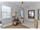 Comfortable seating area features a side table, lamp, and view of the neighborhood at 216 Kirkland Dr, New Smyrna Beach, FL 32169