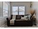 Close up of sofa in living room with a large window to provide natural light at 216 Kirkland Dr, New Smyrna Beach, FL 32169