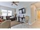 Comfortable living room with sofa, neutral paint, ceiling fan, and lots of natural light at 216 Kirkland Dr, New Smyrna Beach, FL 32169